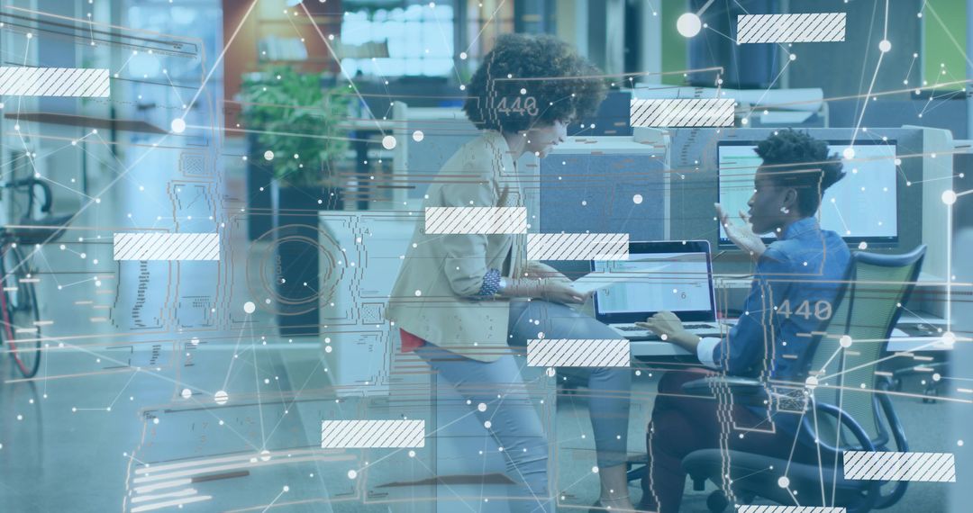 Colleagues Collaborating on Data Presentation in Modern Office