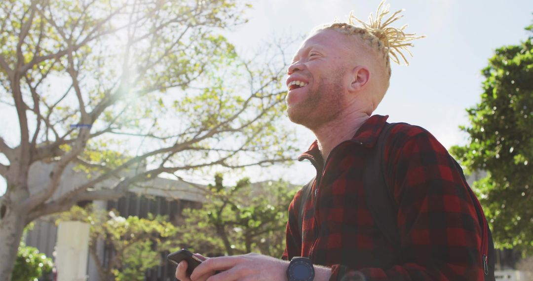 Happy Student with Smartphone and Backpack Enjoying Campus Day