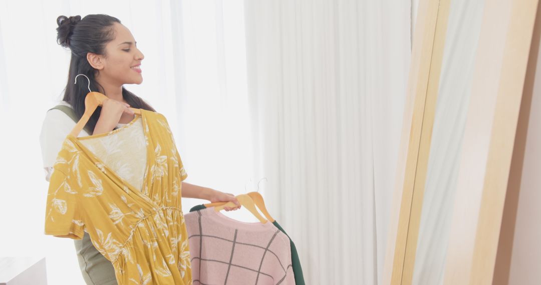 Woman choosing outfit in dressing room with mirror