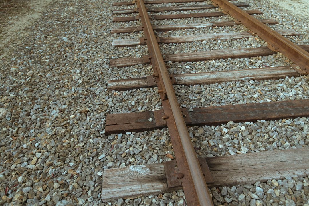 Abandoned Railway Tracks with Weathered Wooden Sleepers