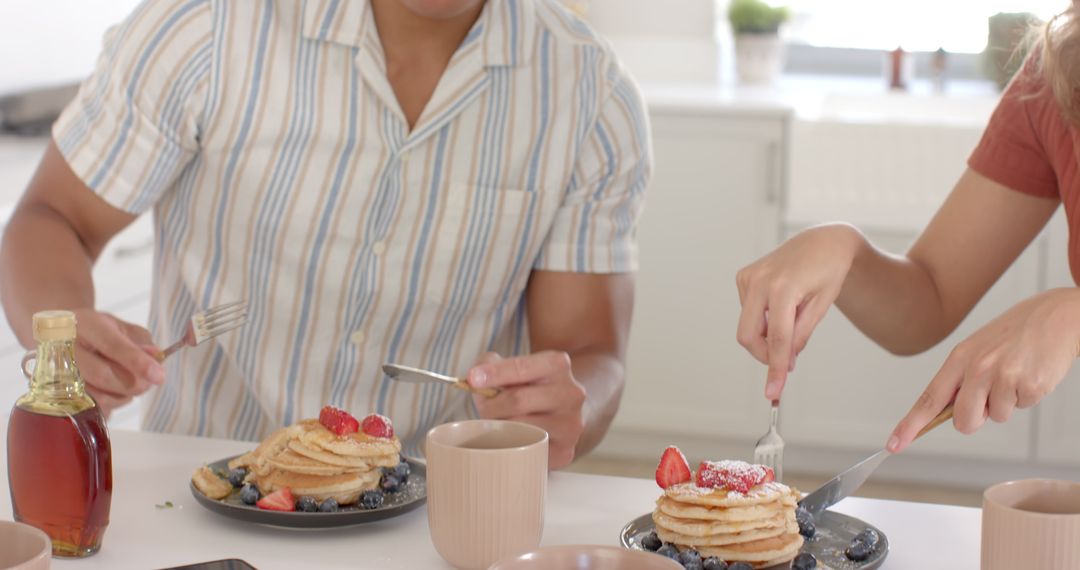 Couple Enjoys Breakfast with Pancakes and Fresh Strawberries