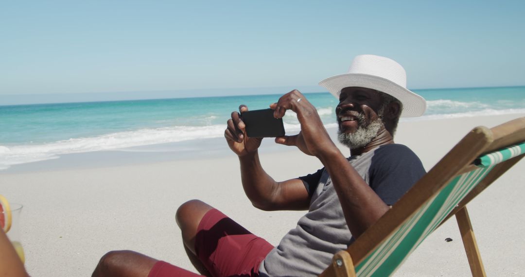 Senior Man Taking Photo on Beach Vacation - Free Images, Stock Photos and Pictures on Pikwizard.com