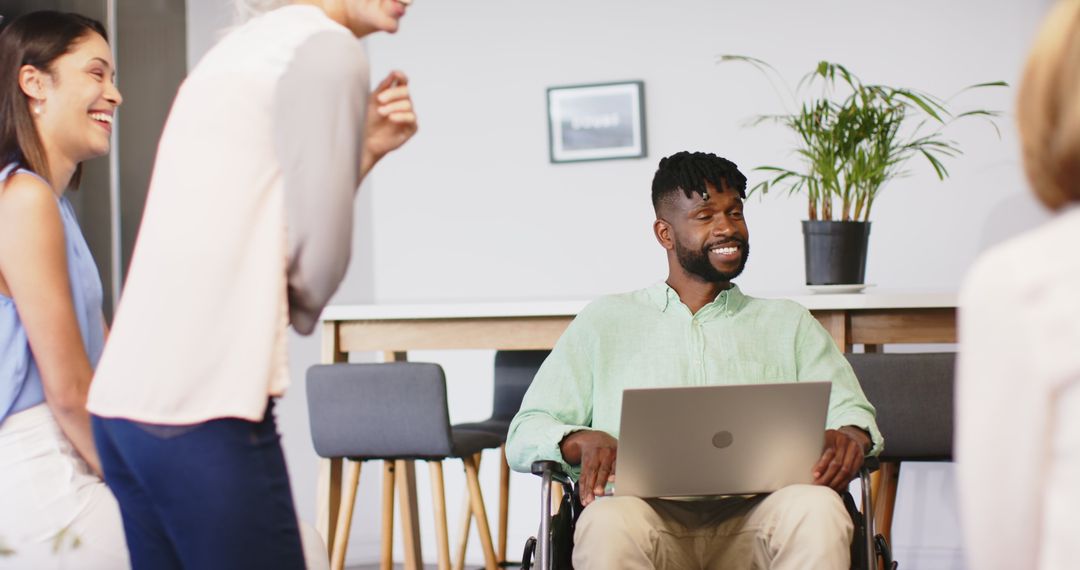 Diverse Team Meeting: Smiling Professional in Wheelchair Leading Discussion