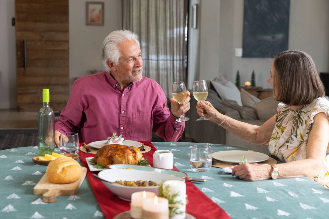 Senior Couple Toasting with Wine During Cozy Meal