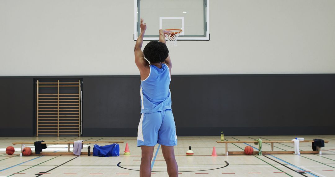 Young basketball player practicing shooting in gym - Free Images, Stock Photos and Pictures on Pikwizard.com