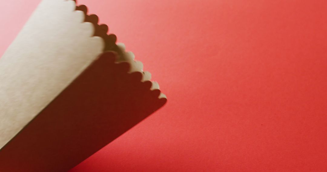 Close-up of White Popcorn Tub on Red Background with Copy Space
