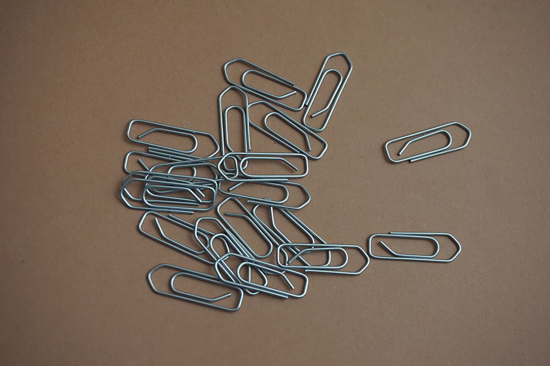 Pile of Paperclips on Brown Surface - Free Images, Stock Photos and Pictures on Pikwizard.com