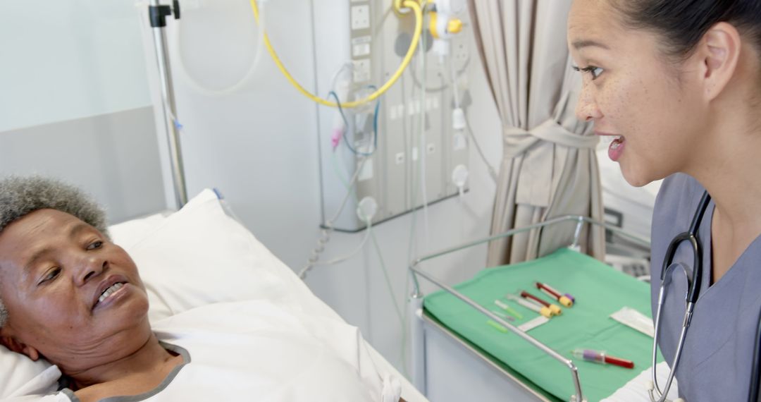 Female Doctor Offering Care to Senior Female Patient in Hospital
