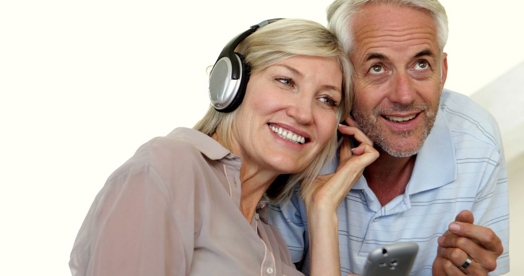 Senior Couple Enjoying Music Together with Headphones - Free Images, Stock Photos and Pictures on Pikwizard.com