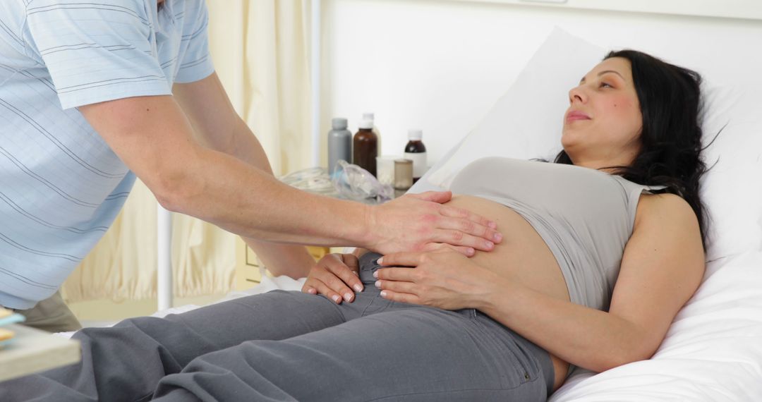 Pregnant Woman Receiving Abdominal Checkup in Hospital Bed - Free Images, Stock Photos and Pictures on Pikwizard.com