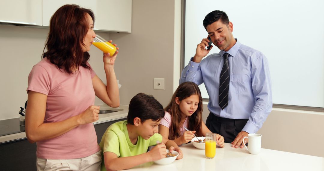 Busy Family Having Breakfast at Home in Modern Kitchen - Free Images, Stock Photos and Pictures on Pikwizard.com