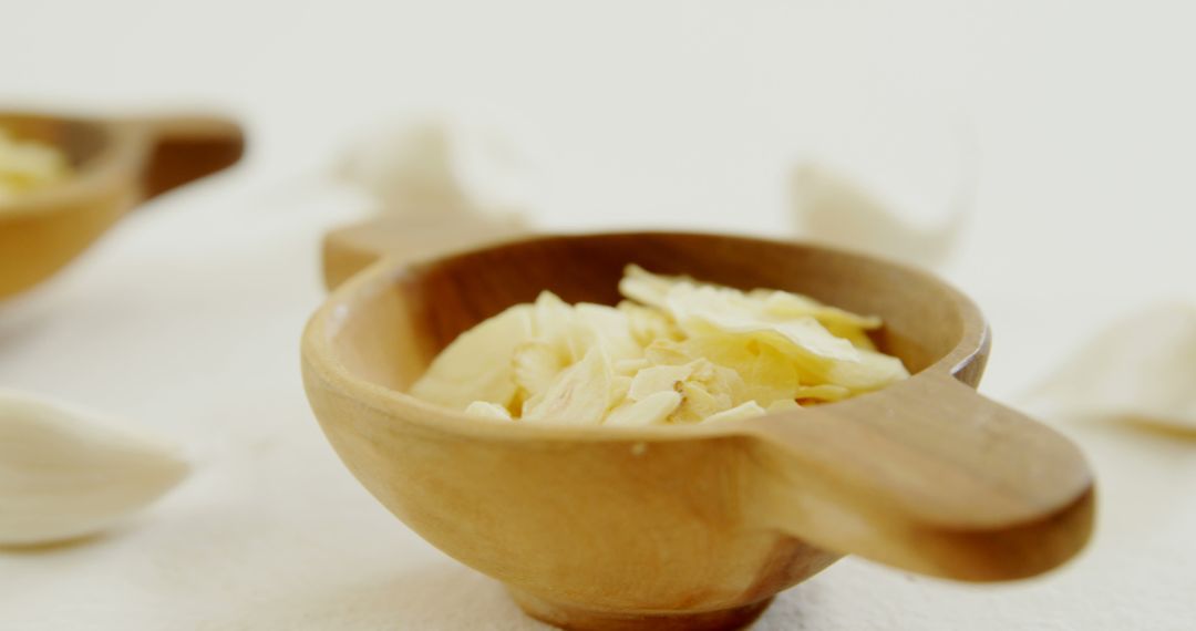 Wooden Bowl with Sliced Garlic on White Background - Free Images, Stock Photos and Pictures on Pikwizard.com