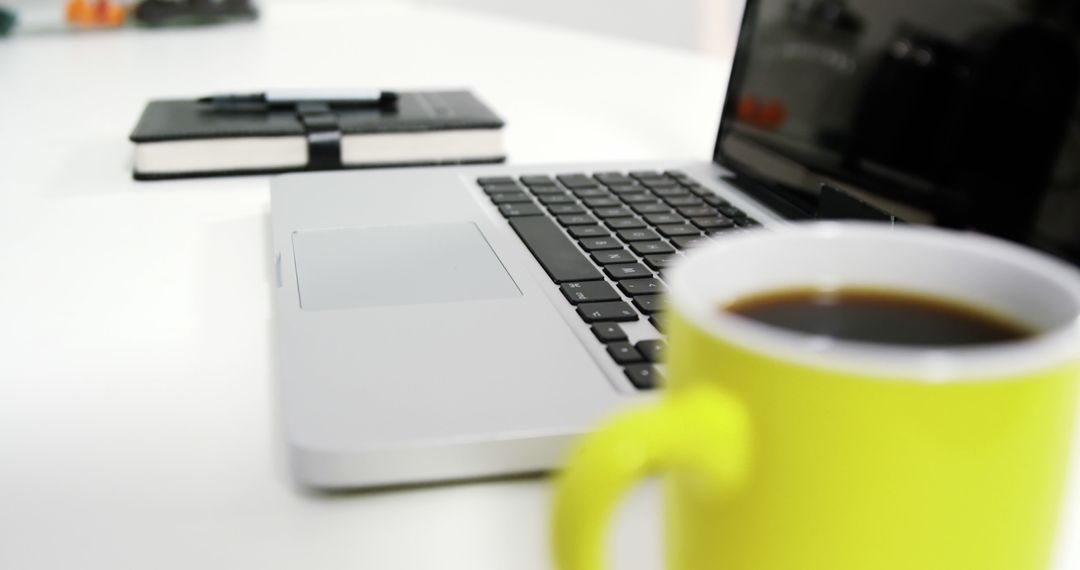 Cozy Workspace with Laptop and Coffee Mug on Kitchen Table