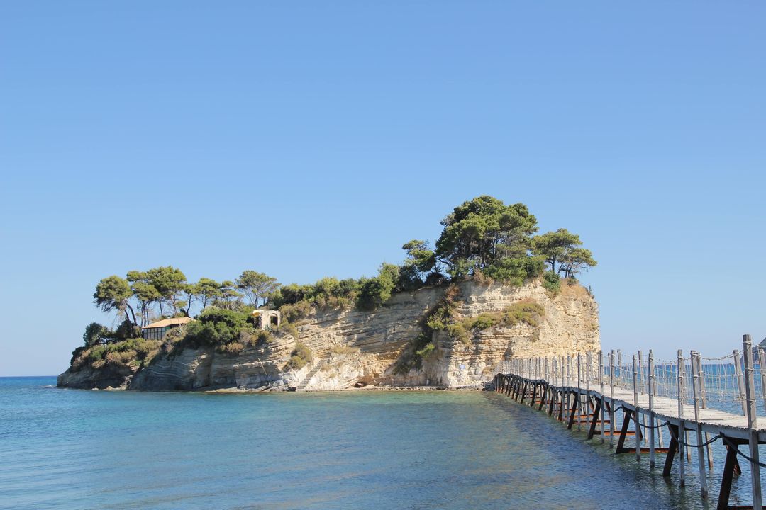 Serene Coastal Island with Pathway and Pine Trees