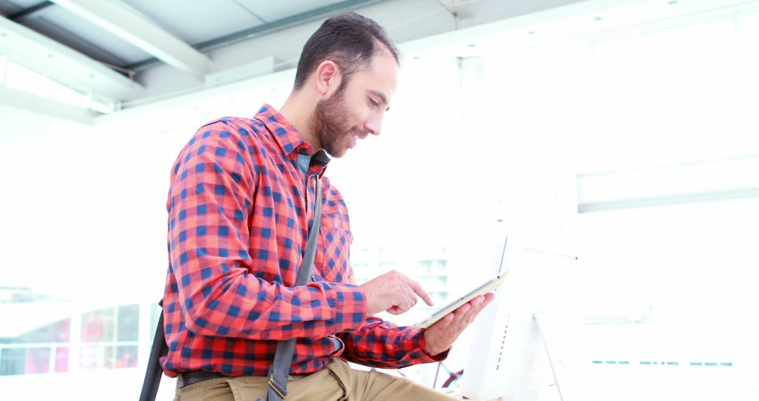 Man Engaged with Tablet in Modern Workplace