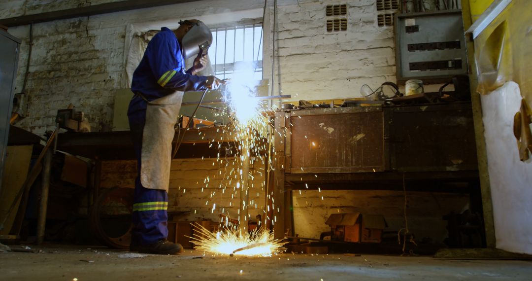 Industrial Worker Wearing Protective Gear Welding Metal - Free Images, Stock Photos and Pictures on Pikwizard.com