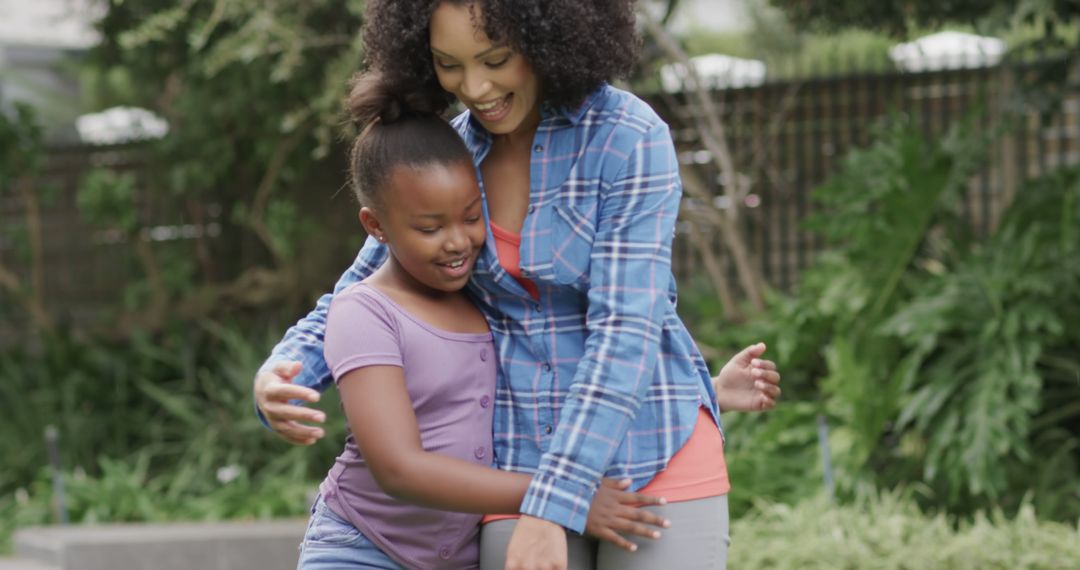 Happy African American Mother and Daughter Hugging Outdoors - Free Images, Stock Photos and Pictures on Pikwizard.com