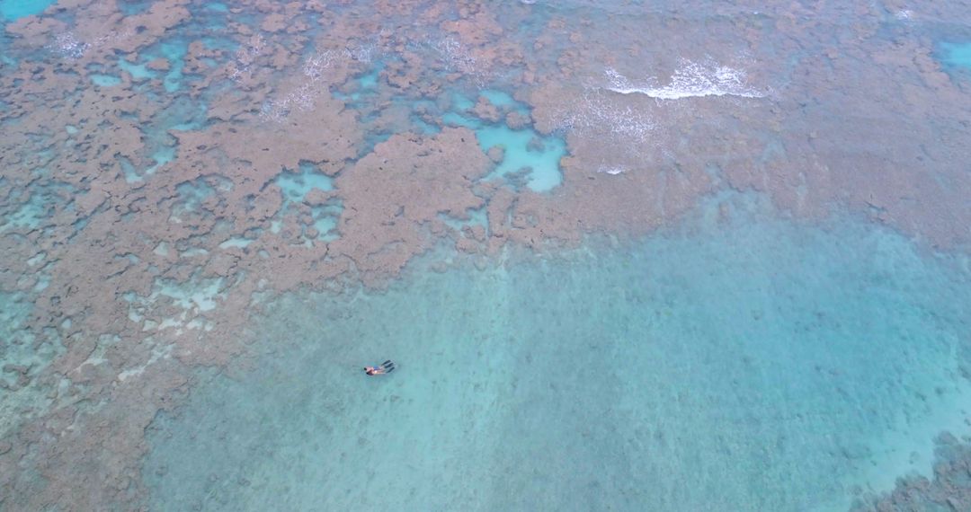 Aerial View of Great Barrier Reef with Kayaker on Blue Water - Free Images, Stock Photos and Pictures on Pikwizard.com