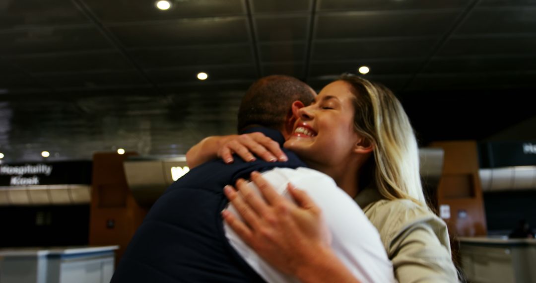 Joyful Reunion of Friends Embracing at Train Station - Free Images, Stock Photos and Pictures on Pikwizard.com