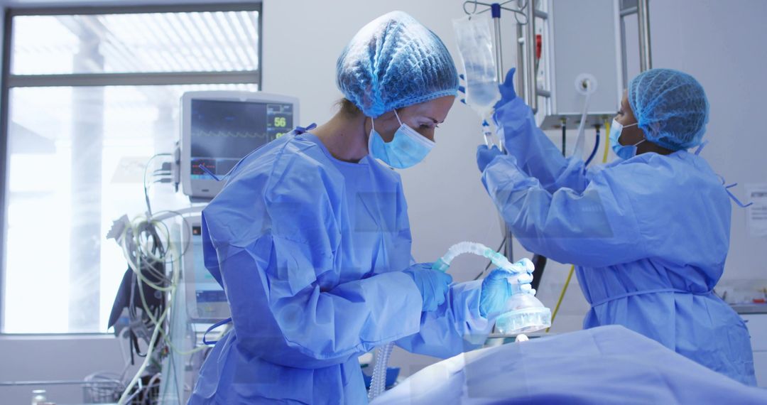 Surgical team administering anesthesia and adjusting IV in modern operating room