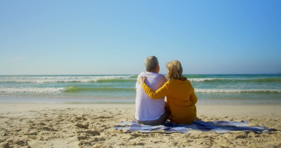 Senior Couple Enjoying Serene Beach View in Warm Embrace