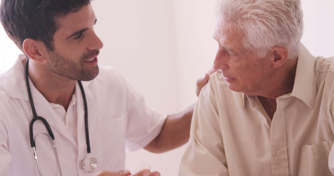 Young Doctor Consulting with Senior Patient in Medical Setting - Free Images, Stock Photos and Pictures on Pikwizard.com