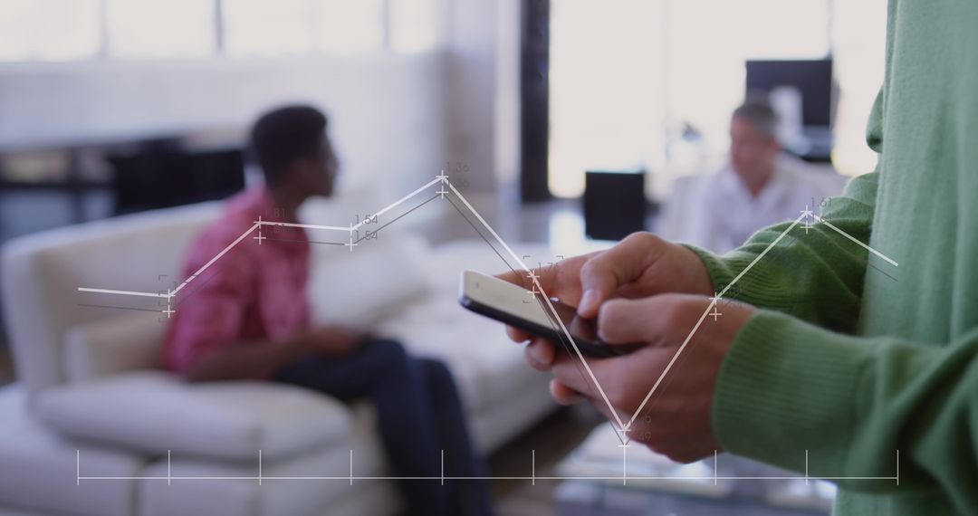 Businessman Using Smartphone for Financial Data Analysis in Modern Office