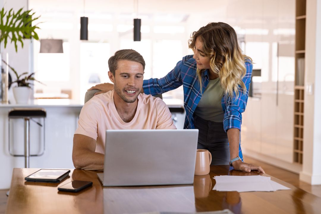 Couple Collaborates at Dining Table Efficiently Using Technology