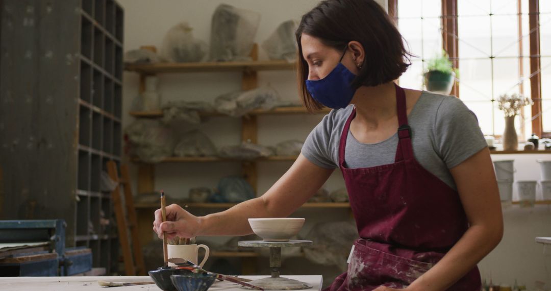 Focused Woman Making Pottery in Studio - Free Images, Stock Photos and Pictures on Pikwizard.com