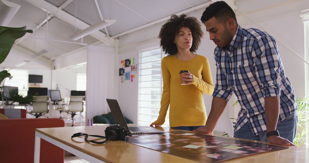 Creative Professionals Collaborating on Desk Project