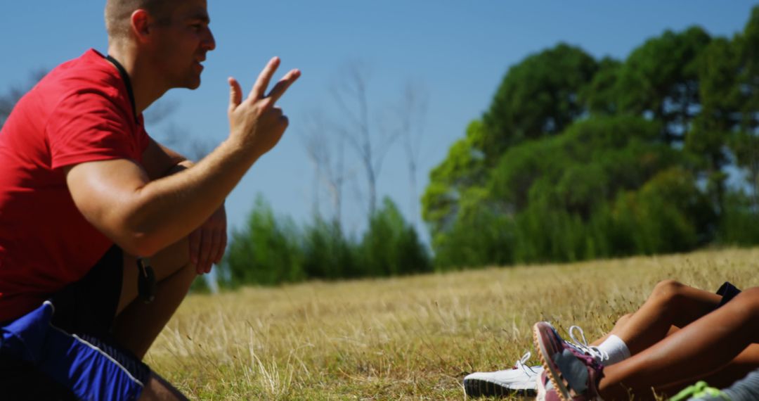 Trainer Assisting Children During Outdoor Boot Camp