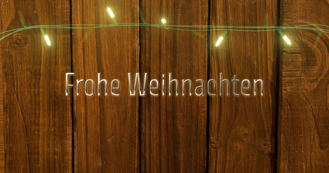 Frohe Weihnachten Text with Fairy Lights on Wooden Background