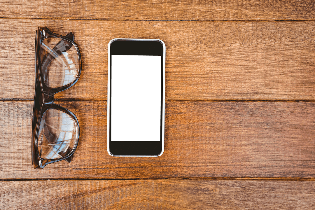 Transparent Glasses and Smartphone on Rustic Wood Desk