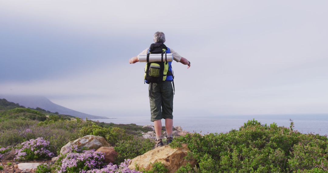 Senior Hiker Embracing Open Nature on a Mountain Trail