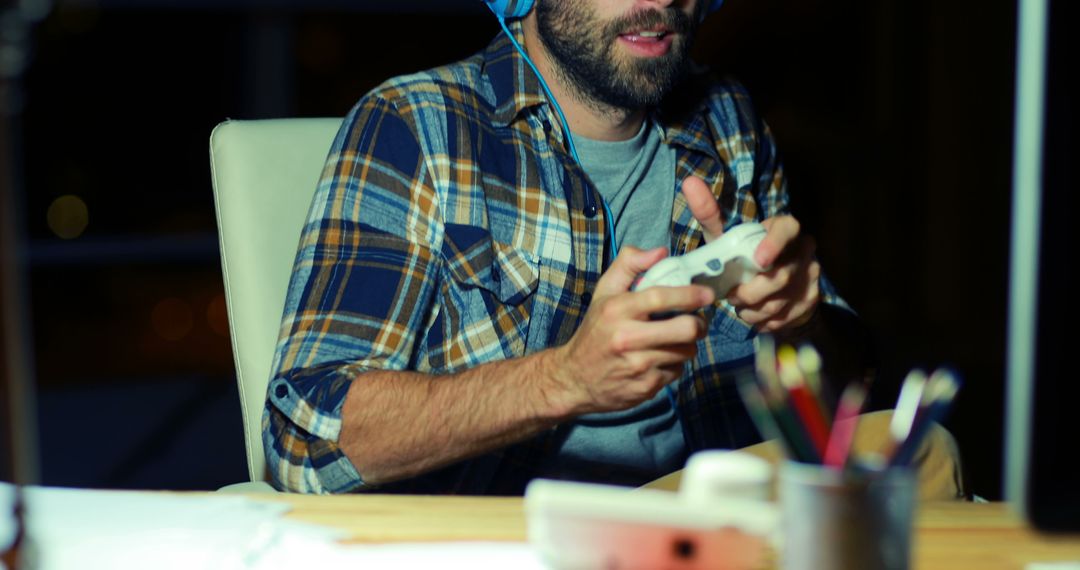 Man Playing Video Game with Headphones at Night - Free Images, Stock Photos and Pictures on Pikwizard.com