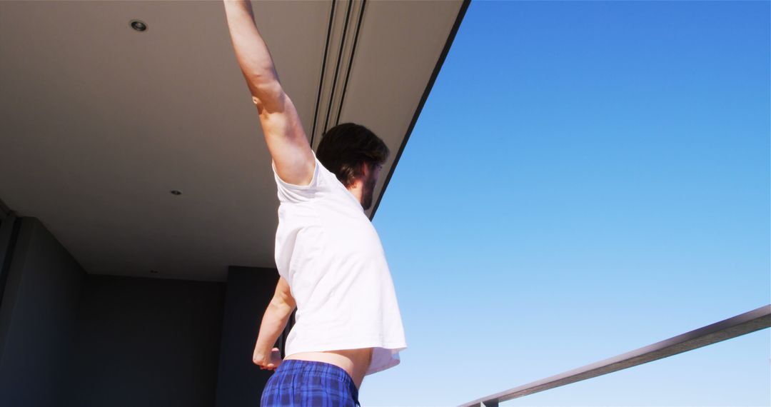 Man Stretching in Morning on Balcony - Free Images, Stock Photos and Pictures on Pikwizard.com