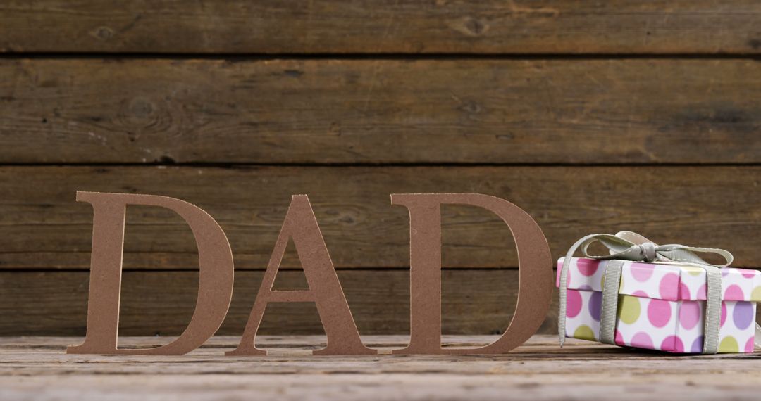 Dad Block Letters with Gift Box on Rustic Wooden Background - Free Images, Stock Photos and Pictures on Pikwizard.com