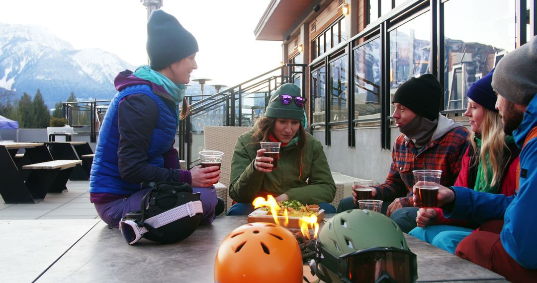 Friends Enjoying Winter Drink Outdoors with Mountain View - Free Images, Stock Photos and Pictures on Pikwizard.com