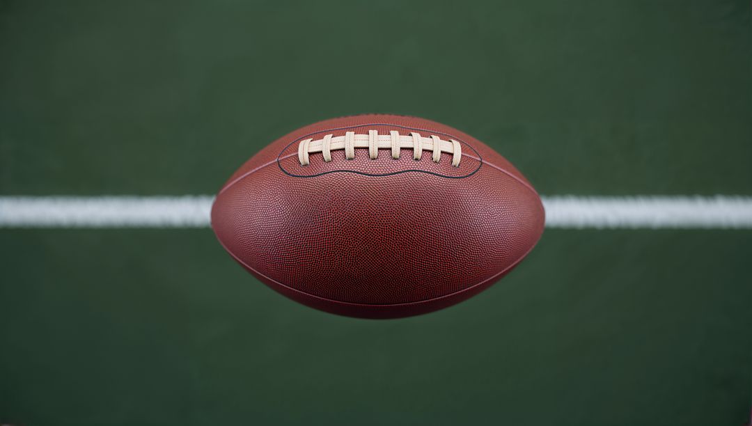 American Football Hovering Over Field Turf with Yard Line