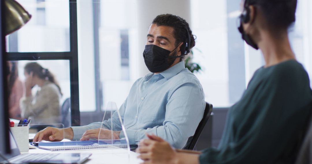 Office Workers with Masks Discussing Project at Workstations