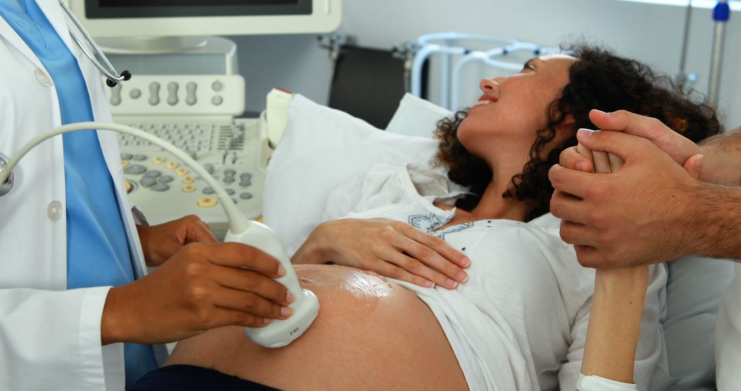 Pregnant woman receiving prenatal ultrasound, comforted by partner - Free Images, Stock Photos and Pictures on Pikwizard.com