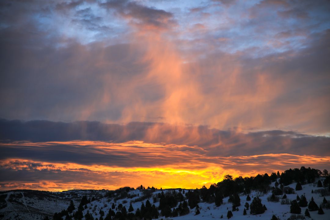 Beautiful Sunset Over Snowy Hills and Trees in Winter - Free Images, Stock Photos and Pictures on Pikwizard.com