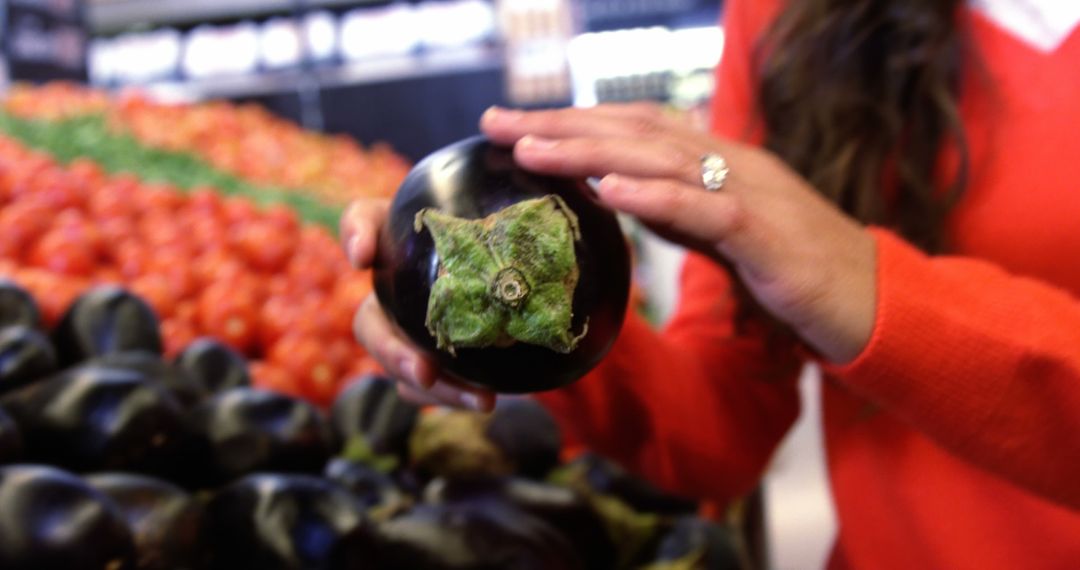 Woman Choosing Fresh Eggplant at Market - Free Images, Stock Photos and Pictures on Pikwizard.com