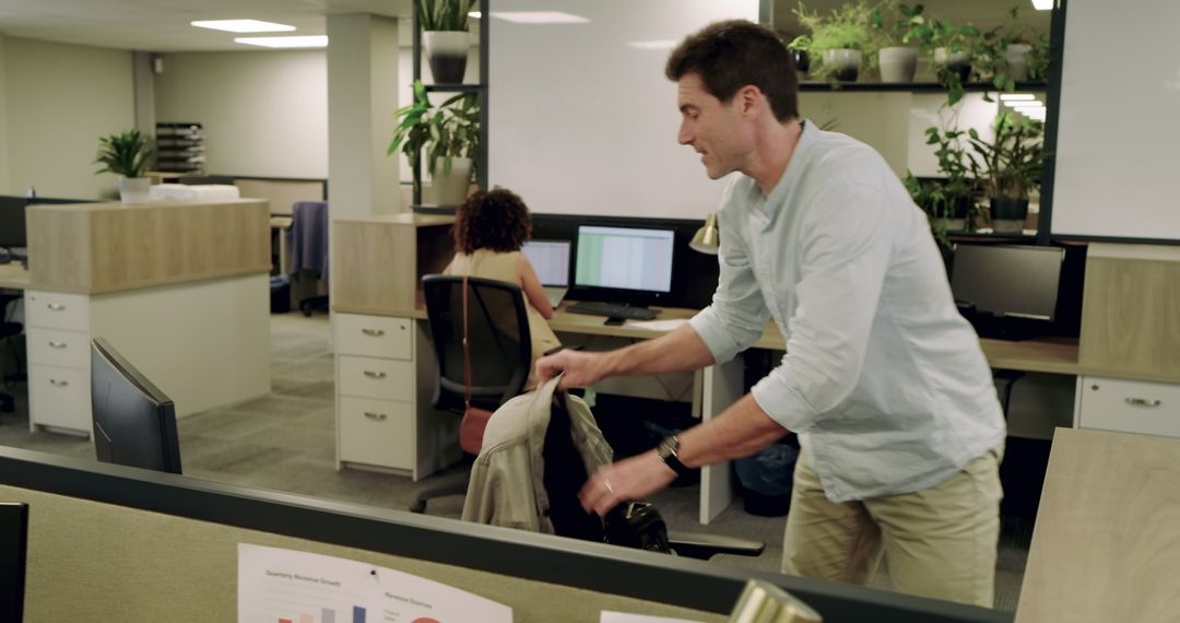 Colleagues Organizing Workspace in Modern Office Environment