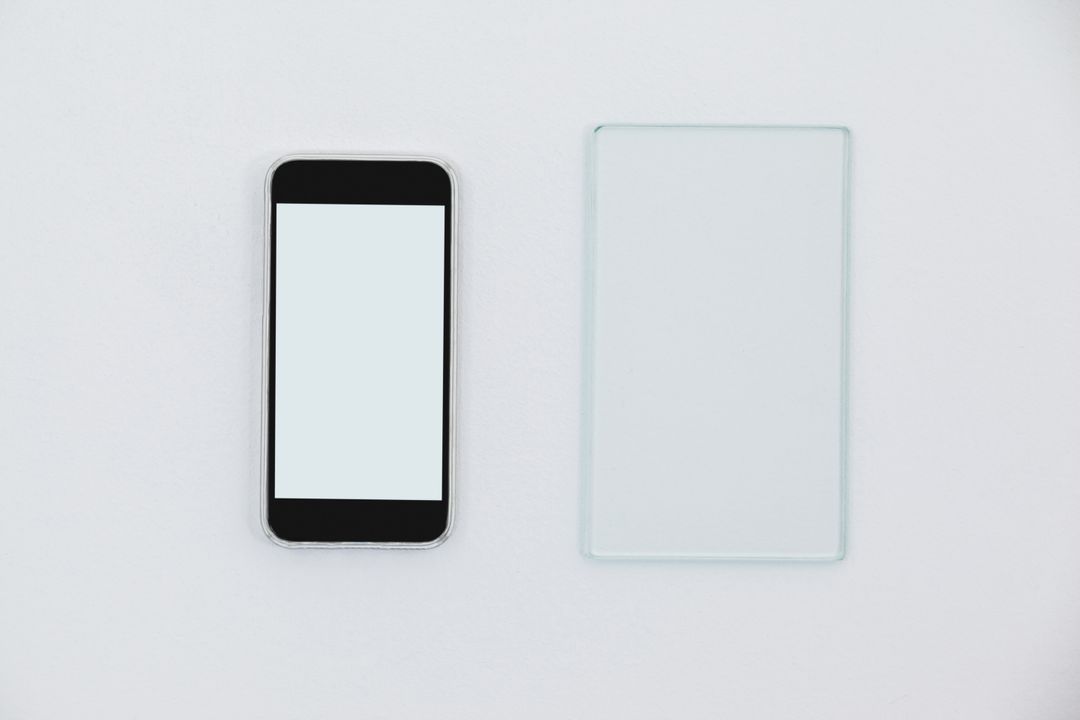 Sheet of glass and mobile phone on white background - Free Images, Stock Photos and Pictures on Pikwizard.com