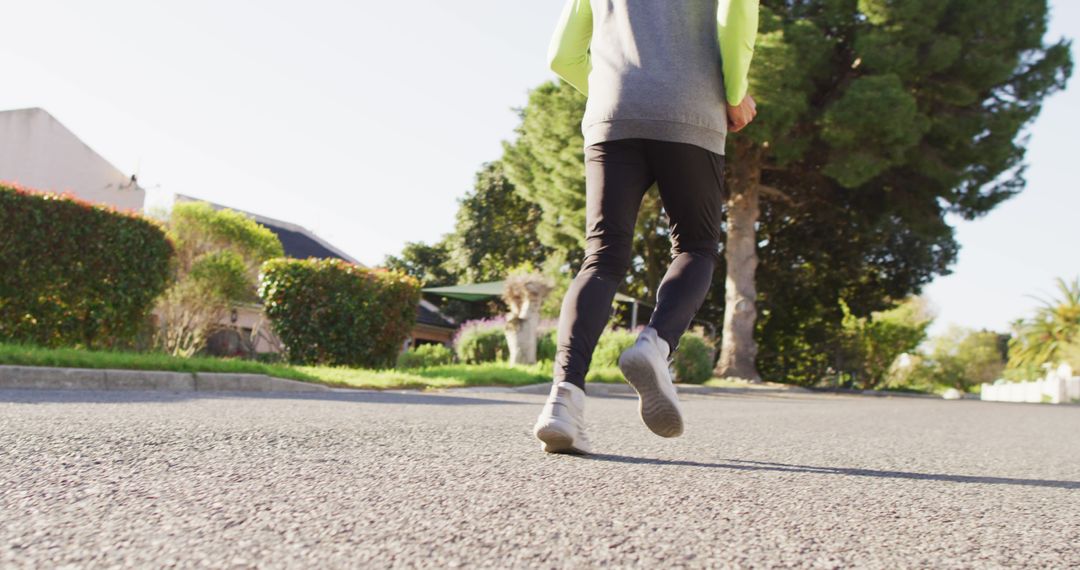 Person Jogging on Suburban Road in Morning Light - Free Images, Stock Photos and Pictures on Pikwizard.com