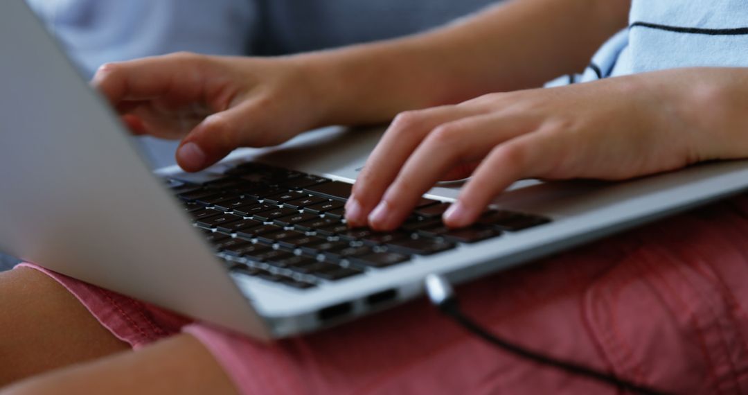 Hands Typing on Laptop Keyboard in Lap - Free Images, Stock Photos and Pictures on Pikwizard.com