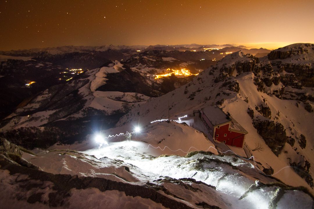 Mountain Summit Under Starry Sky with Glowing City in Background - Free Images, Stock Photos and Pictures on Pikwizard.com