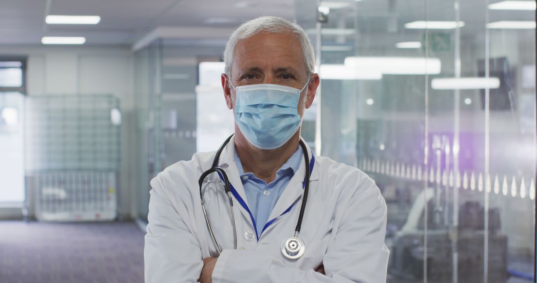 Experienced Male Doctor Wearing Mask in Modern Hospital - Free Images, Stock Photos and Pictures on Pikwizard.com