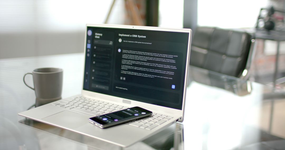 Home Office Desk with AI Chatbot on Laptop and Smartphone